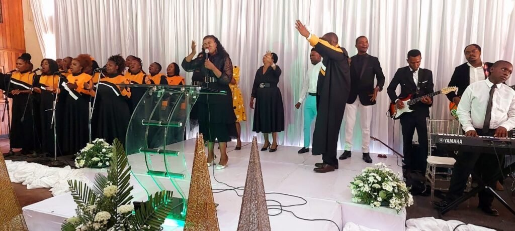 The choir and ministers worshipping on stage at a TCI assembly