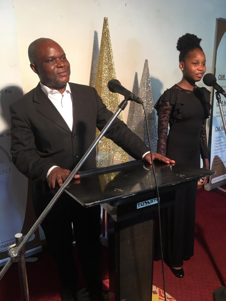 A minister speaking at the pulpit at TCI DR Congo