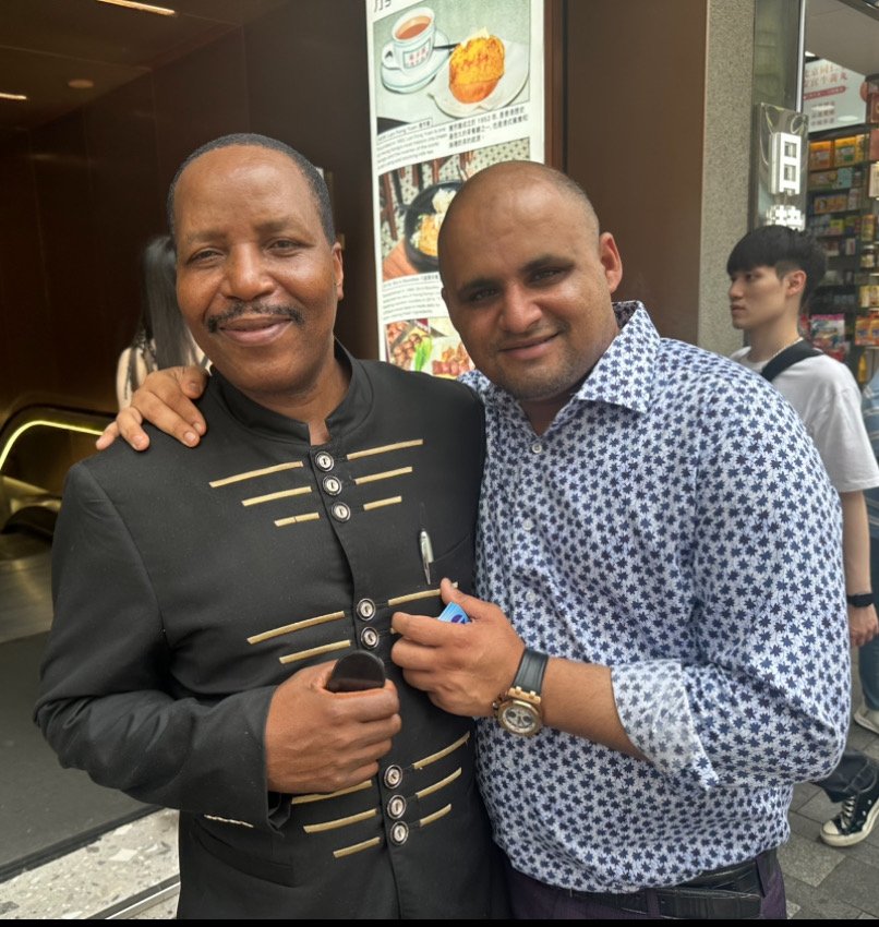 A TCI leader with a friend at a restaurant during the Global Tour