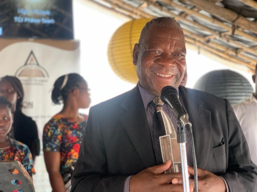 A TCI Mozambique minister smiling at the microphone