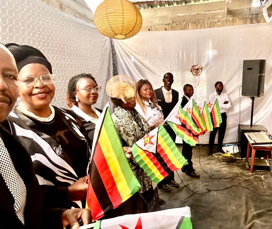 TCI Zimbabwe members waving the national flag during a service