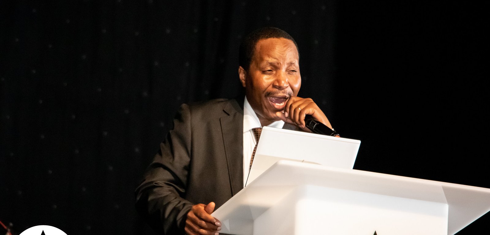A minister preaching at a Testimony of Christ International service