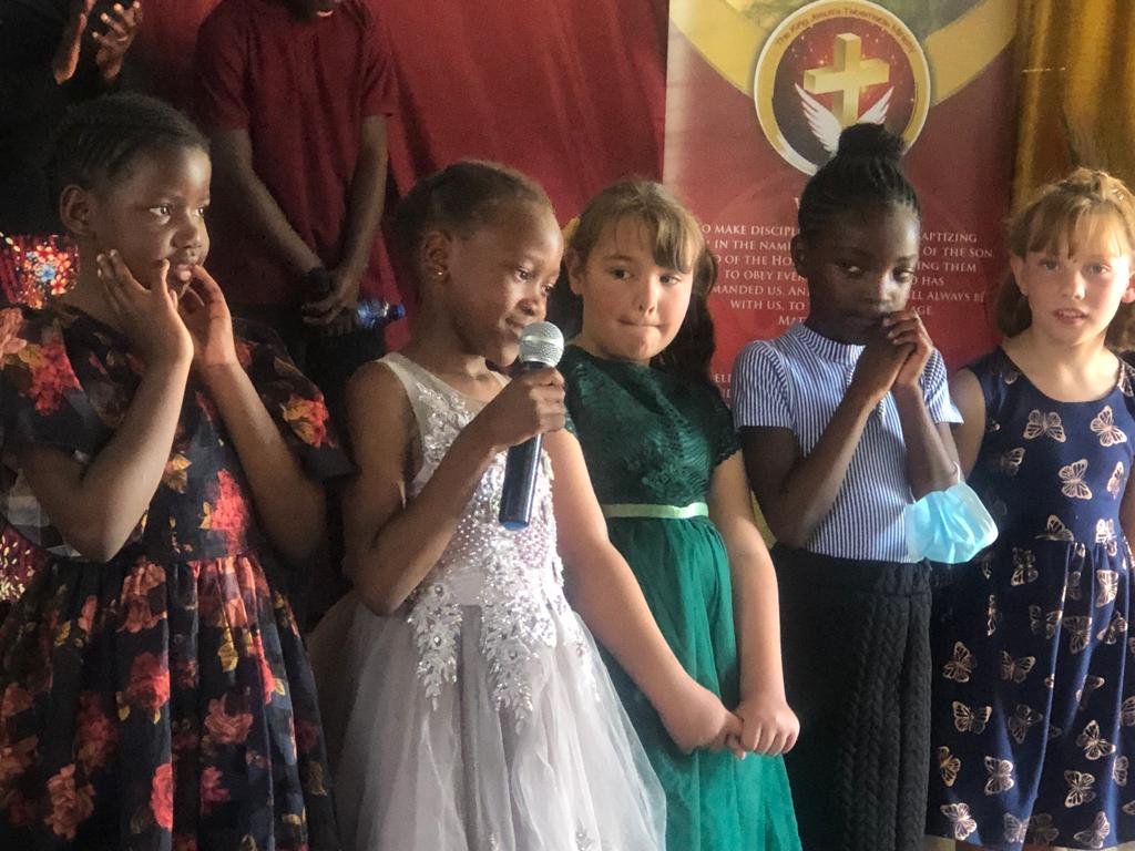 Children singing together at a TCI service