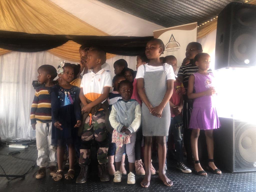 TCI children standing together on stage