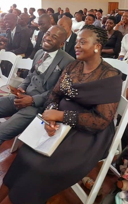 A couple seated together at a TCI service
