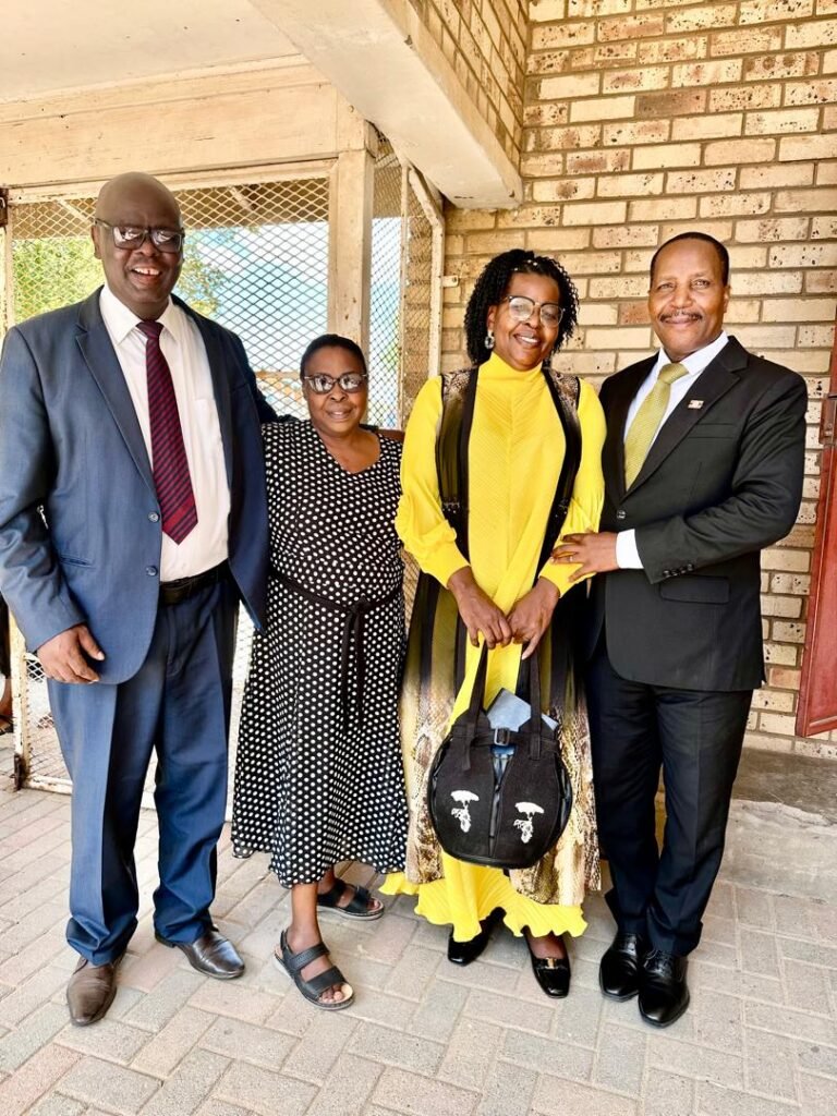 Two TCI couples standing together outside a church building