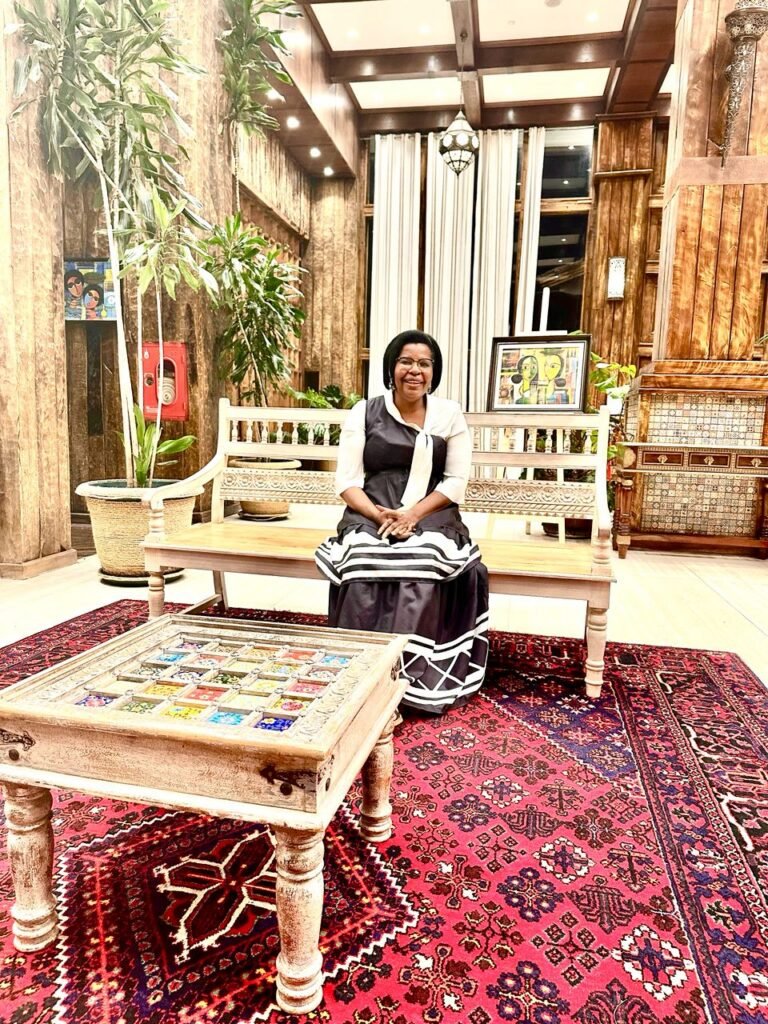 A TCI mother seated in a richly decorated lounge