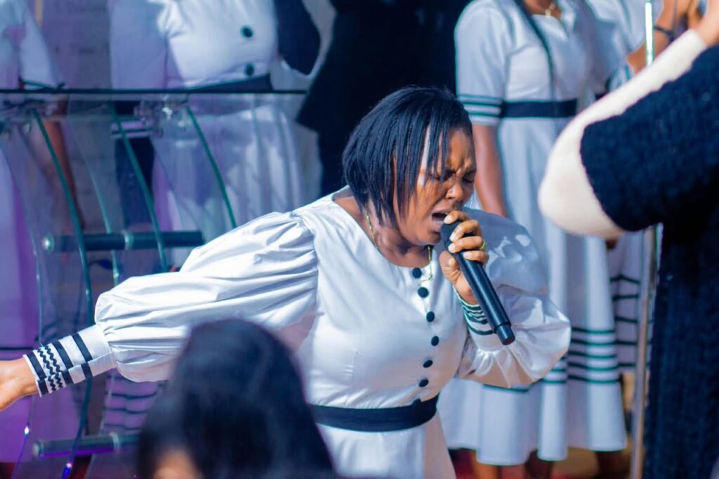 A woman preaching passionately at a TCI service