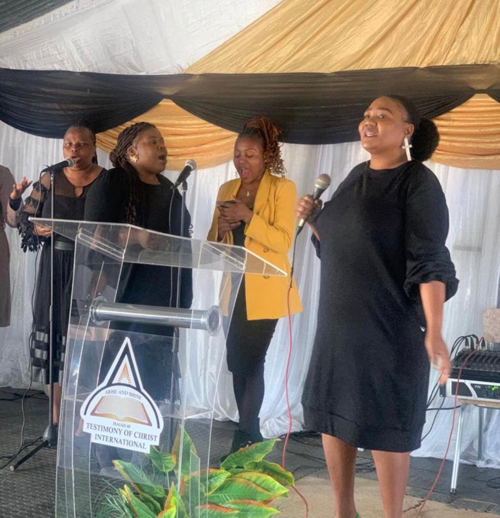 Women ministering together at the front of a TCI service