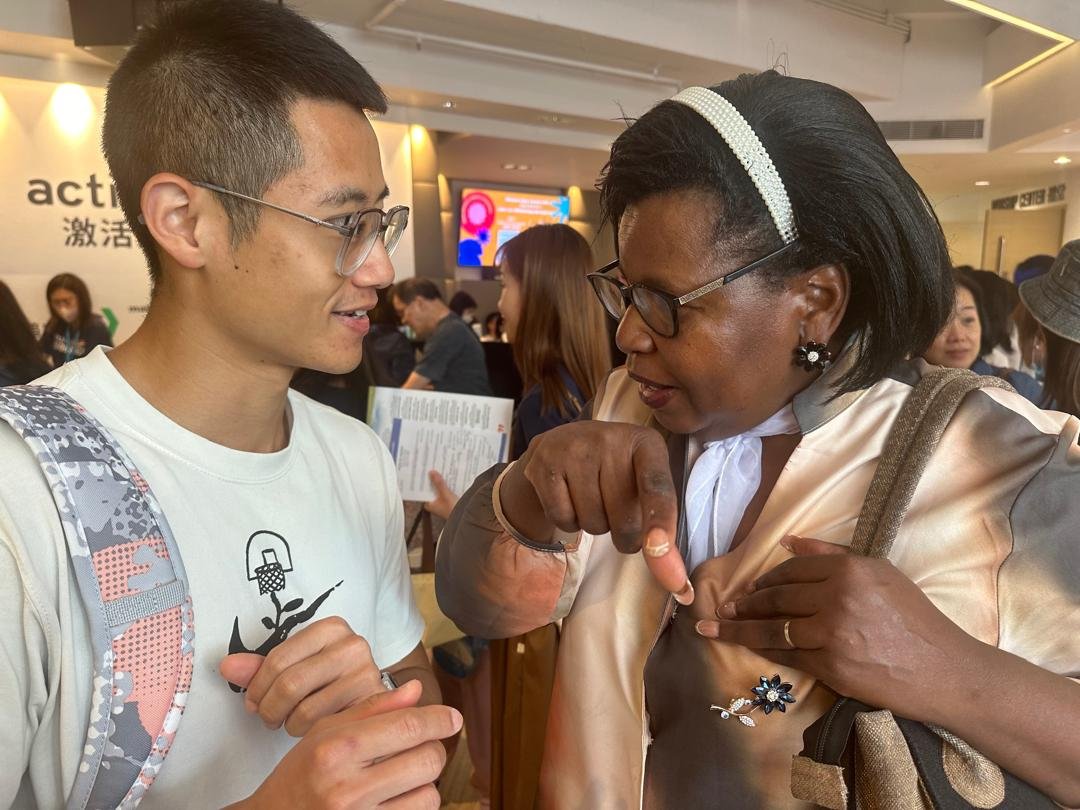 A TCI member sharing the gospel one-on-one with a young man at a public event